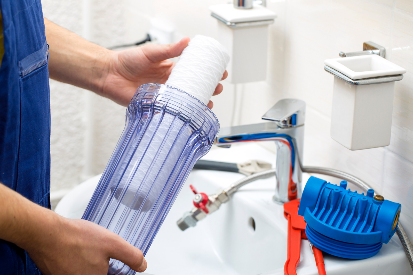 Plumber installing water filters